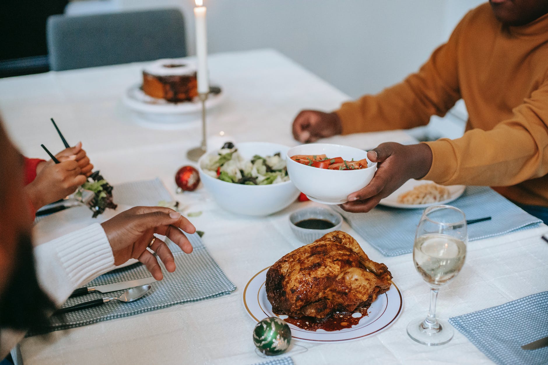 crop black relatives at served table with christmas meal